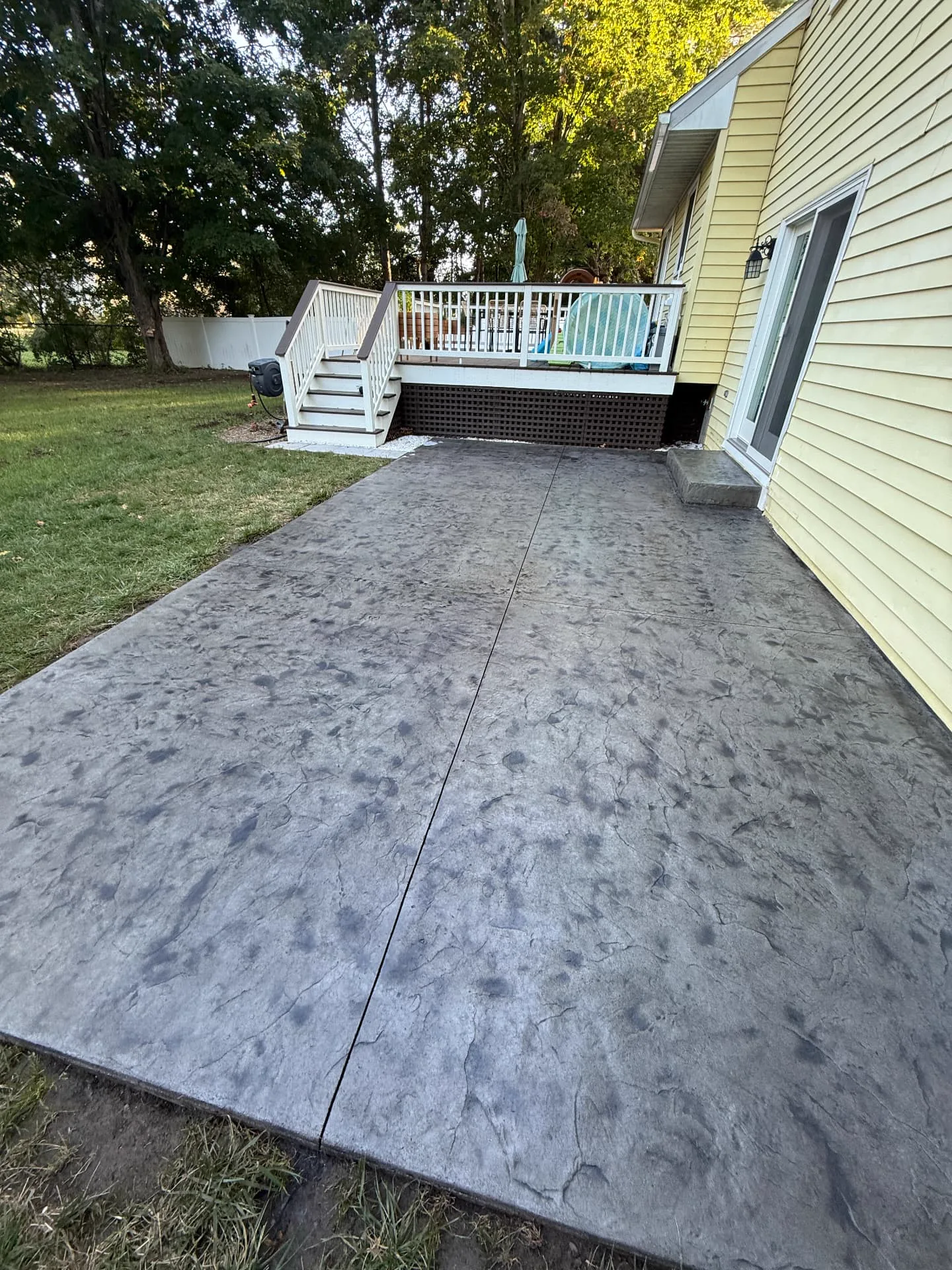 Final dark gray stamped concrete patio after antiquing and sealing