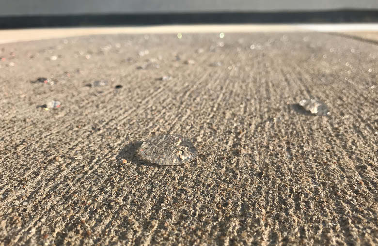 Water beading on a sealed concrete surface in the Capital Region
