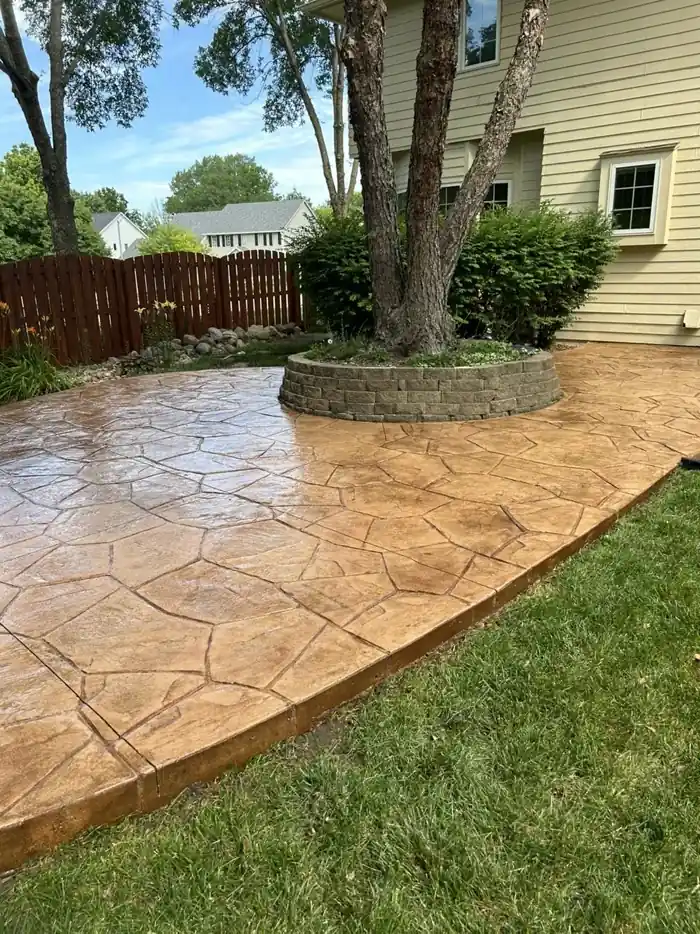 Tan flagstone stamped concrete patio sealed with a wet-look sealer