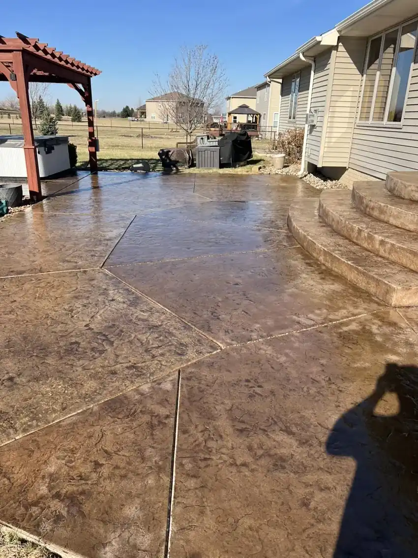 Brown stamped concrete patio and steps freshly sealed