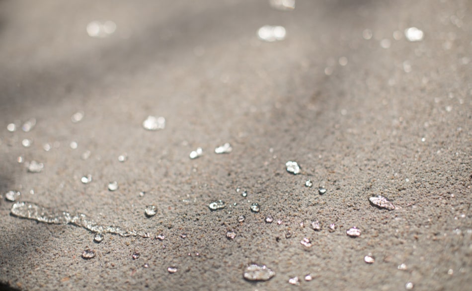 Rain water beading on concrete protected with a penetrating sealer