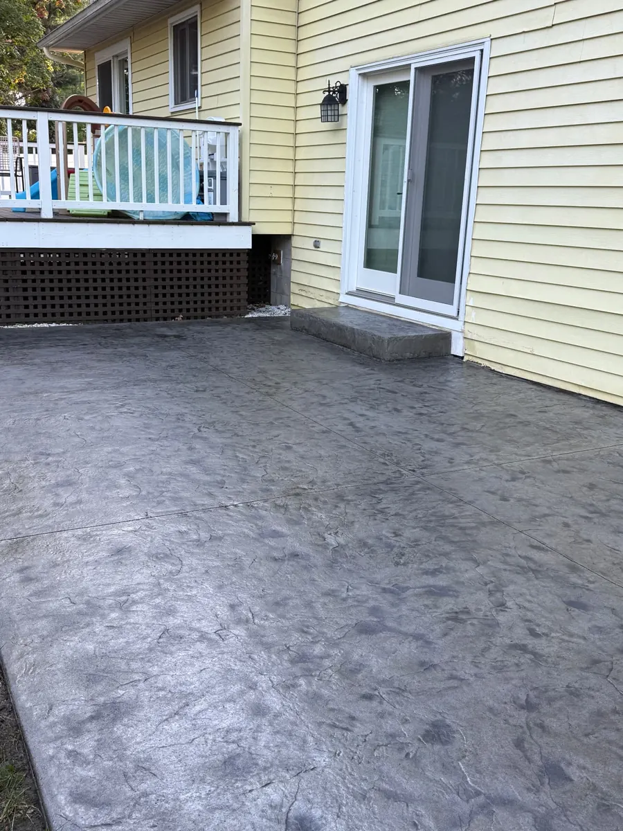 Close view of a finished dark gray stamped concrete patio